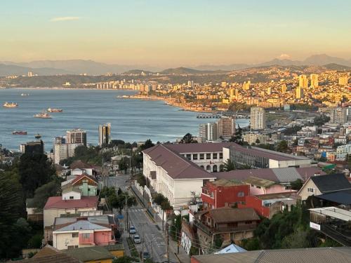 a view of a city with the water and buildings at Hotel Faro Azul Valparaíso Cerro Alegre in Valparaíso