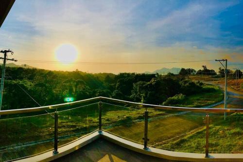 a view of the sunset from the roof of a building at Staycation At Sandari Batulao Overlooking Spot in Tagaytay