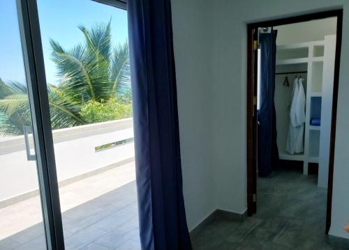 a mirror in a room with a view of a window at Sipano Beach Lodge Kiwengwa in Kiwengwa