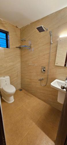 a bathroom with a toilet and a sink at BLUEWAY RESIDENCY DOWNTOWN HOTEL in Trivandrum