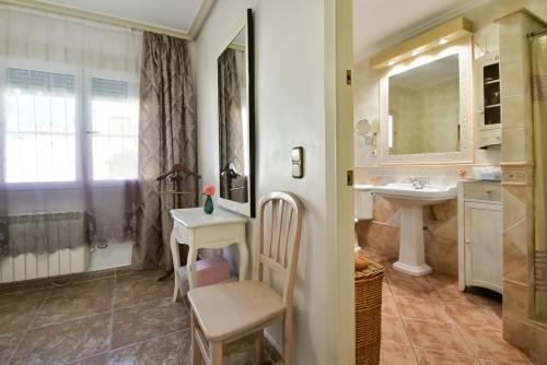W łazience znajduje się umywalka, stół i lustro. w obiekcie Casa CAMPOAMOR w mieście Orihuela