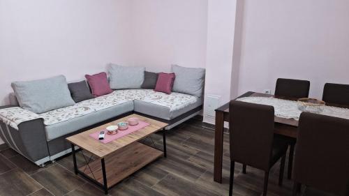 a living room with a couch and a table at Apartman Jelena in Cetinje