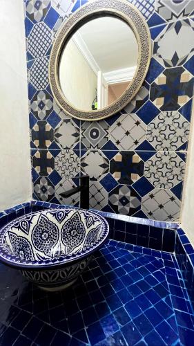 a bathroom with a sink and a mirror at Riad Al Nour in Marrakech