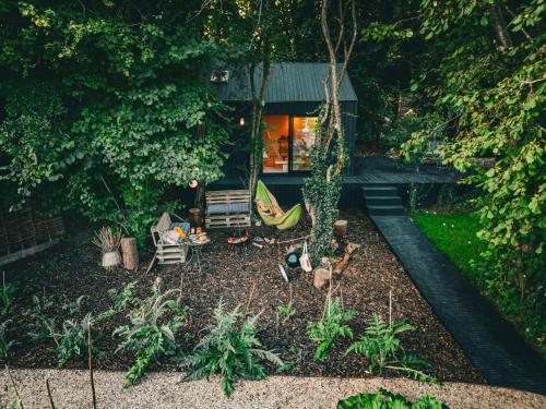 a backyard with a hammock and a house at Bay House Studio in Bath