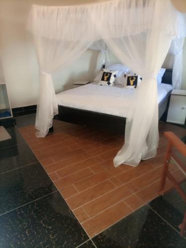 a bed with a canopy in a room at OLOIRIEN HOTEL & RESORT in Narok
