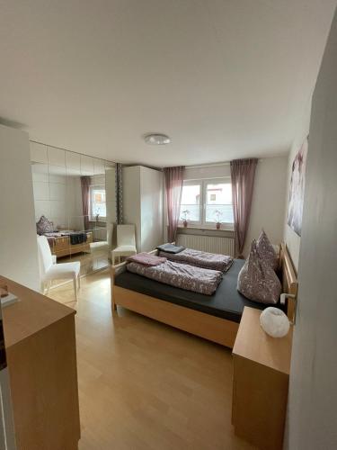 a bedroom with a bed and a living room at Ferienwohnung Blessinger in Coburg