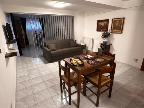 a living room with a table and a couch at LA CASA IN COLLINA in Veroli