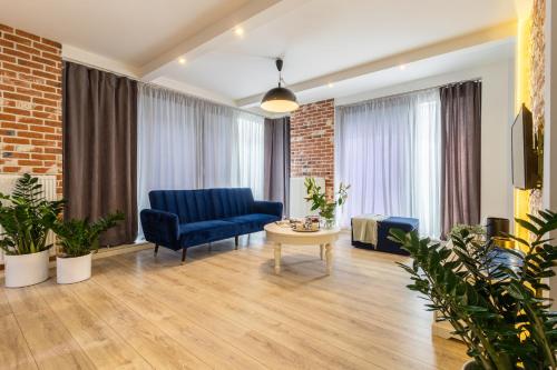 a living room with a blue couch and a table at AbsyntApart Krawiecka - Just in Center Wrocław Rynek - MAMY WOLNE POKOJE ! in Wrocław