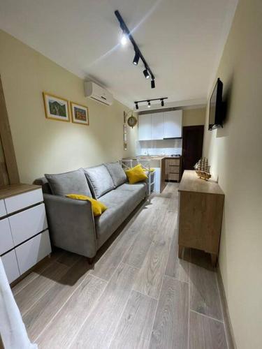 a living room with a couch and a kitchen at Sofia's Garage in Tbilisi City