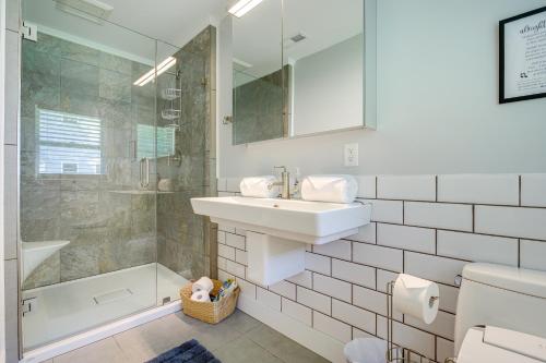 a white bathroom with a sink and a shower at Modern Fayetteville Home Near Trilith Studios! in Fayetteville