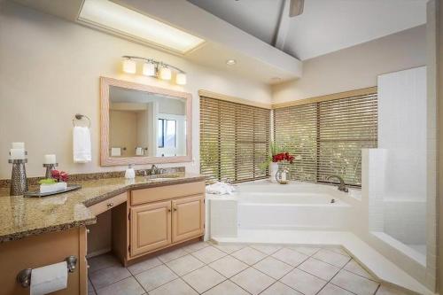 a bathroom with a tub and a sink and a bath tub at Oceanview Luxury Villa Pool & SPA in Kailua-Kona