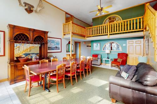 a dining room with a table and chairs and a couch at Scenic View Lodge - Entire Property in Bloomington