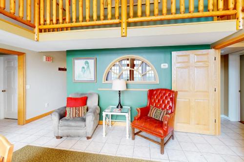 a living room with two chairs and a staircase at Scenic View Lodge - Entire Property in Bloomington