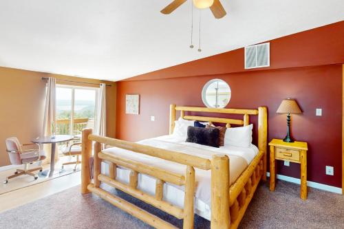 a bedroom with a wooden bed and a table at Scenic View Lodge - Entire Property in Bloomington
