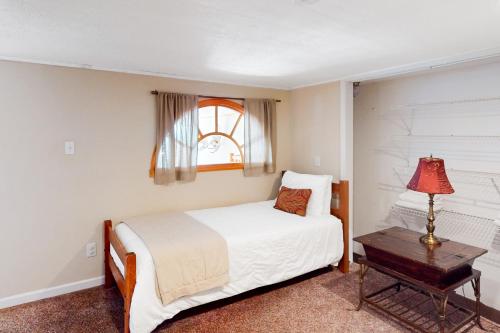 a bedroom with a bed and a table and a window at Scenic View Lodge - Entire Property in Bloomington