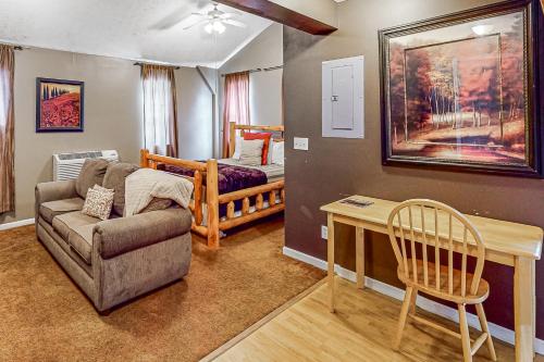 a living room with a couch and a table and a bed at Scenic View Lodge - Entire Property in Bloomington