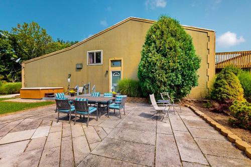 a patio with a table and chairs in front of a building at Scenic View Lodge - Entire Property in Bloomington