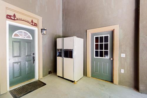 a room with a refrigerator next to two doors at Scenic View Lodge - Entire Property in Bloomington