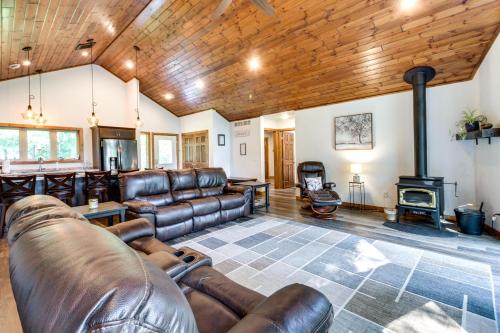 a living room with leather furniture and a wood ceiling at Merrifield Vacation Rental with Dock and River Access in Merrifield