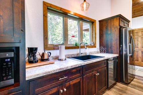 a kitchen with wooden cabinets and a sink at Merrifield Vacation Rental with Dock and River Access in Merrifield