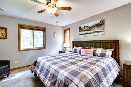 a bedroom with a bed and a ceiling fan at Merrifield Vacation Rental with Dock and River Access in Merrifield