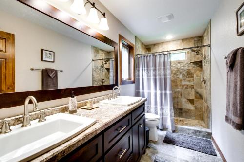 a bathroom with two sinks and a shower at Merrifield Vacation Rental with Dock and River Access in Merrifield