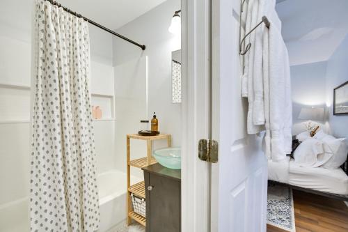a bathroom with a sink and a shower at New Orleans Duplex Walk to Parks and Restaurants! in New Orleans