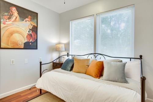 a bedroom with a bed and a painting on the wall at New Orleans Duplex Walk to Parks and Restaurants! in New Orleans