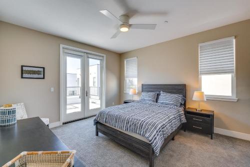 a bedroom with a bed and a table and windows at Ideally Located Sacramento Townhome with 2 Balconies in Sacramento