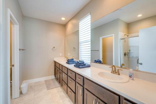 a bathroom with a sink and a mirror at Ideally Located Sacramento Townhome with 2 Balconies in Sacramento