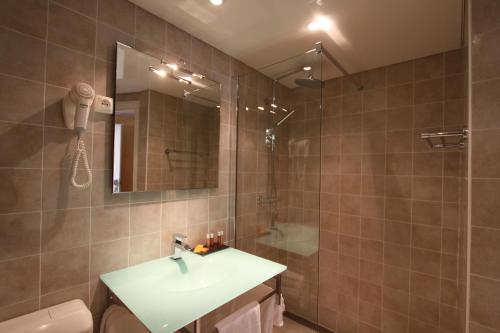 a bathroom with a sink and a shower at Domaine de l'Oriu in Serriera