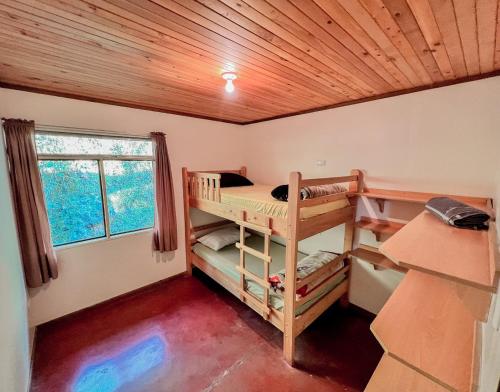 a room with two bunk beds and a window at Hacienda La Lucha in Lucha