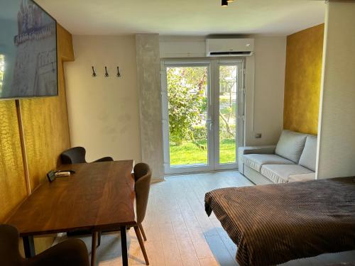 a room with a bed and a table and a couch at APARTMENT GAL in Novo Mesto