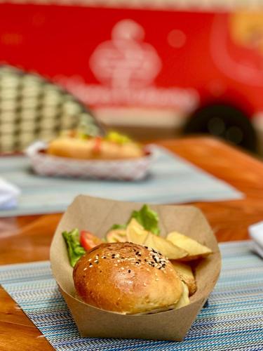 a plate of food with a hamburger and chips on a table at Flamingo Cancun All Inclusive in Cancún