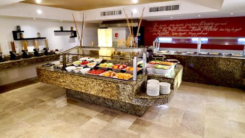a buffet line with many different types of food at Flamingo Cancun All Inclusive in Cancún