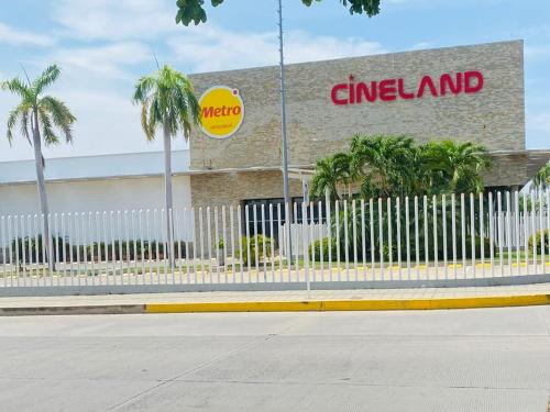 a cima island store with a white fence and palm trees at Mami Yola in Valledupar