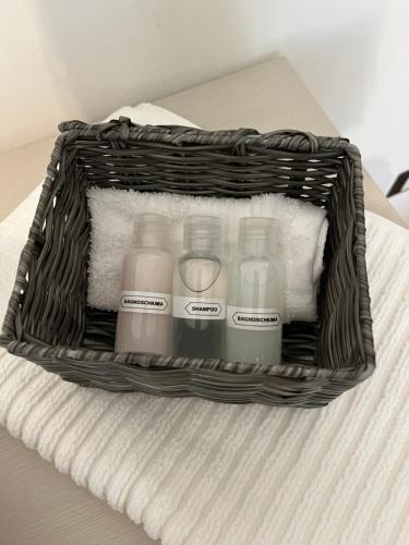 a basket filled with bottles of milk on a bed at Welcome Home Quartu Sant'Elena in Quartu SantʼElena