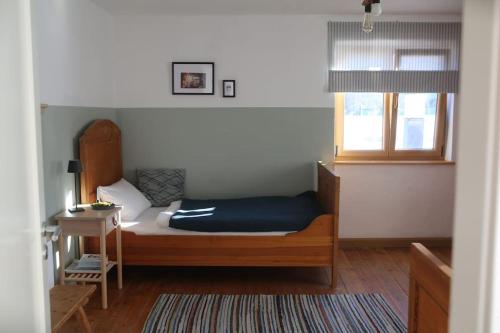 a bedroom with a bed and a window at KampenZeit Ferienwohnung-traumhafter Panoramablick in Aschau im Chiemgau