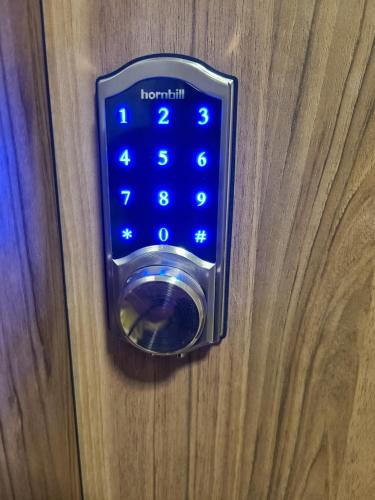 a close up of a door knob with a key board at Fantastic Beach condo with pool and mountain views in Nueva Gorgona