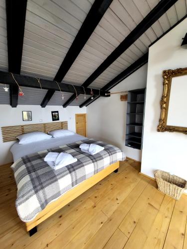 a bedroom with a large bed in a room at HUUT in Zlatibor