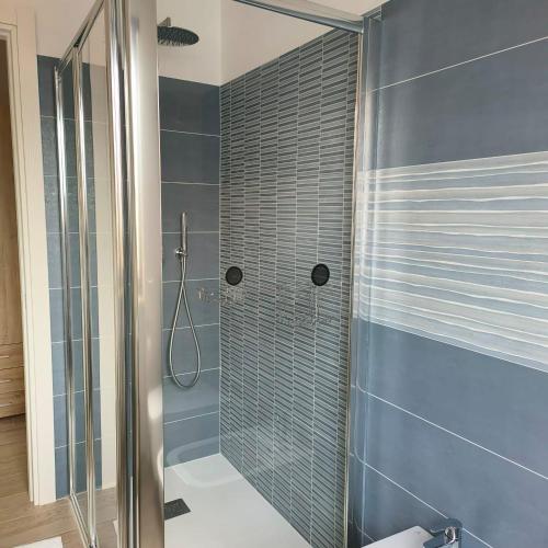 a bathroom with a shower with a glass door at IL PAITITI in Arco