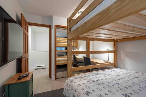 a small bedroom with a bed and a desk at Updated Townhouse in Village. Pool/Hot Tub/Parking in Whistler