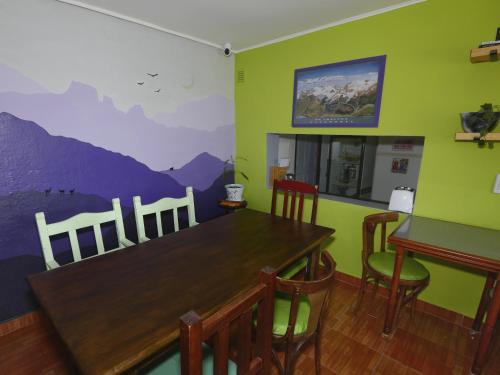 a dining room with a wooden table and chairs at Lago Argentino B&B in El Calafate