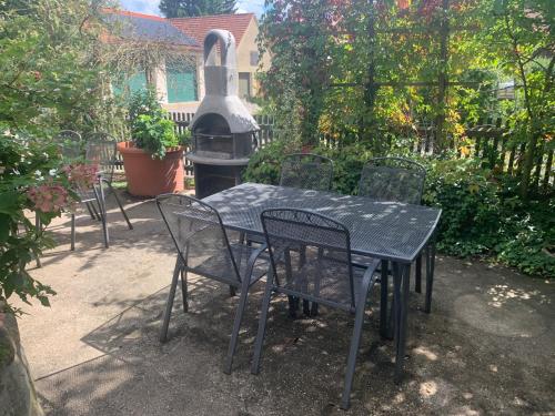 a black table and chairs with a grill in a yard at Ferienhof Klein in Gunzenhausen