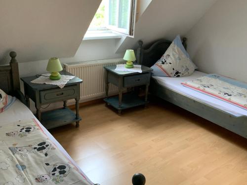 a small room with two beds and two tables at Ferienhof Klein in Gunzenhausen