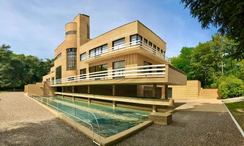 a building with a swimming pool in front of it at Studio Chic Croix-Barbieux in Croix