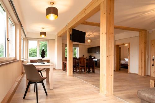 a living room and dining room with a table and chairs at Natur Pur Ferienhaus Falkenhagen in Thale