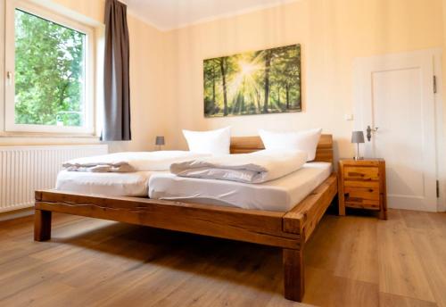 a bedroom with two beds and a large window at Haus Falkenhagen 11 in Thale