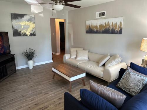 a living room with a couch and a coffee table at Central Chic on Washington in Evansville
