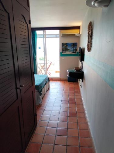 a hallway with a door to a room with a bedroom at Appartements vue mer - Résidence de la baie - Tartane in La Trinité